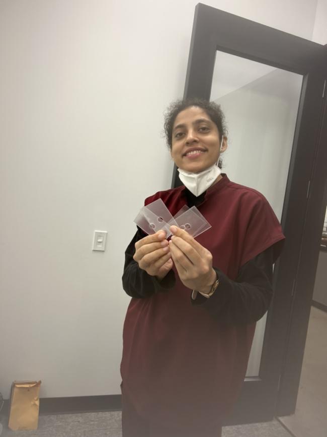 A Foldscope-card-size backing prototype held in hand