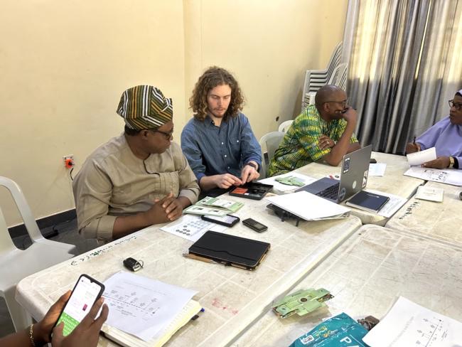 Prof Ekpo and Will examining the SchistoFilter and Foldscope