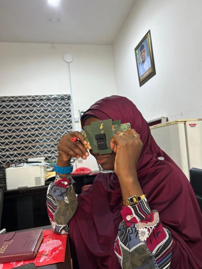 Dr. Soneye looking through a Foldscope