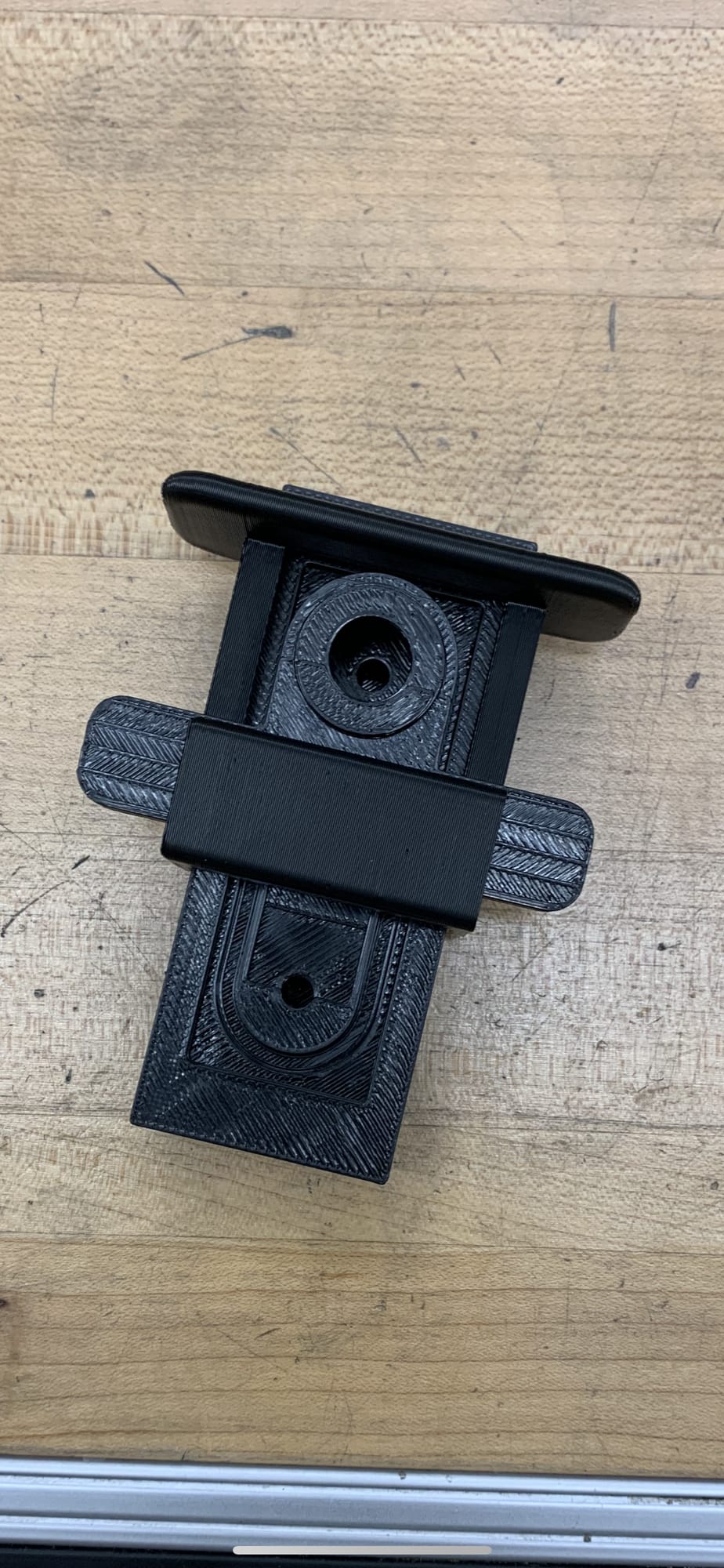 A black 3D-printed casing with a lens spacer and X–Y slider for a single-slide device